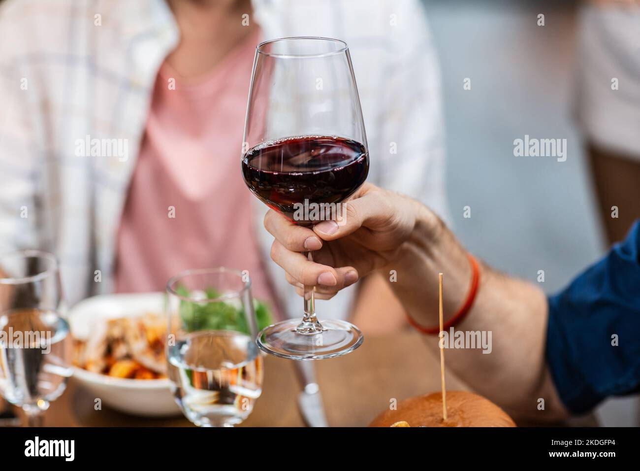 man with glass drinking red wine at restaurant Stock Photo