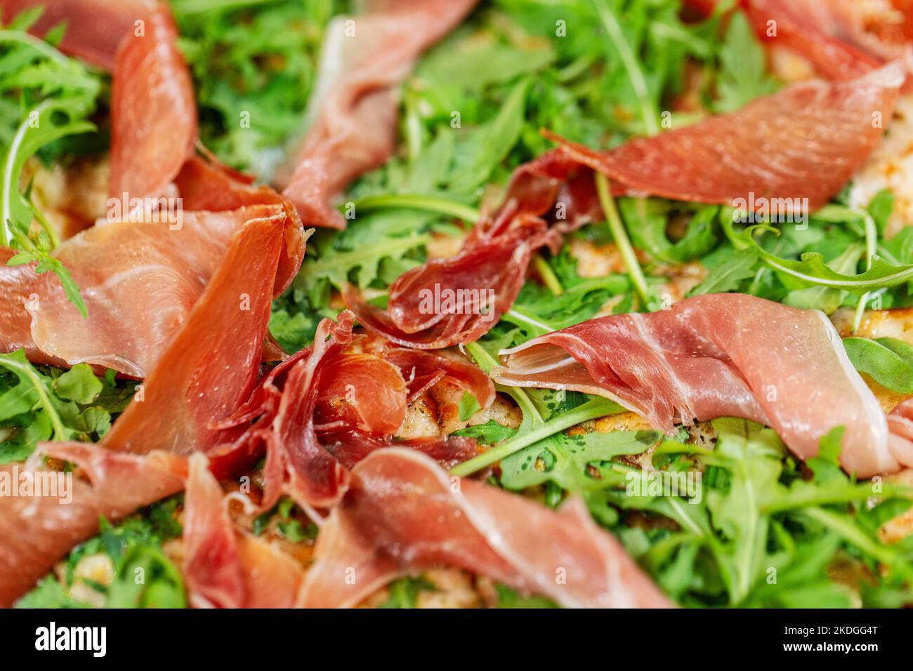 close up of pizza with prosciutto and arugula Stock Photo