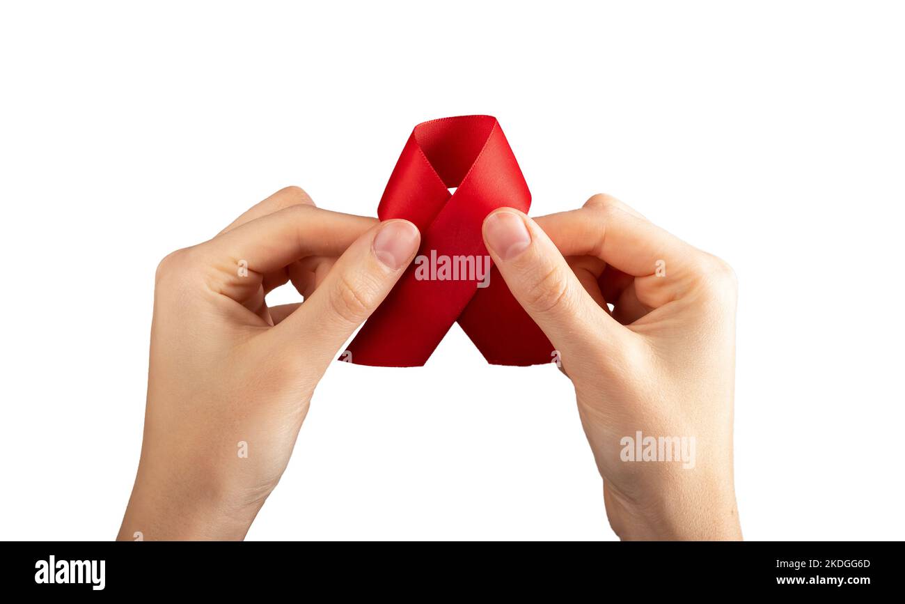 Red satin ribbon in hand isolated on white background. HIV and AIDS ...