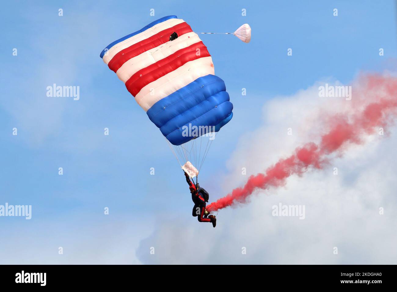 Kleine Brogel, Belgium - SEP 08, 2018: UK Defence RAF parachutists giving a show with smoke on an air show at Kleine Brogel, Belgium. Stock Photo
