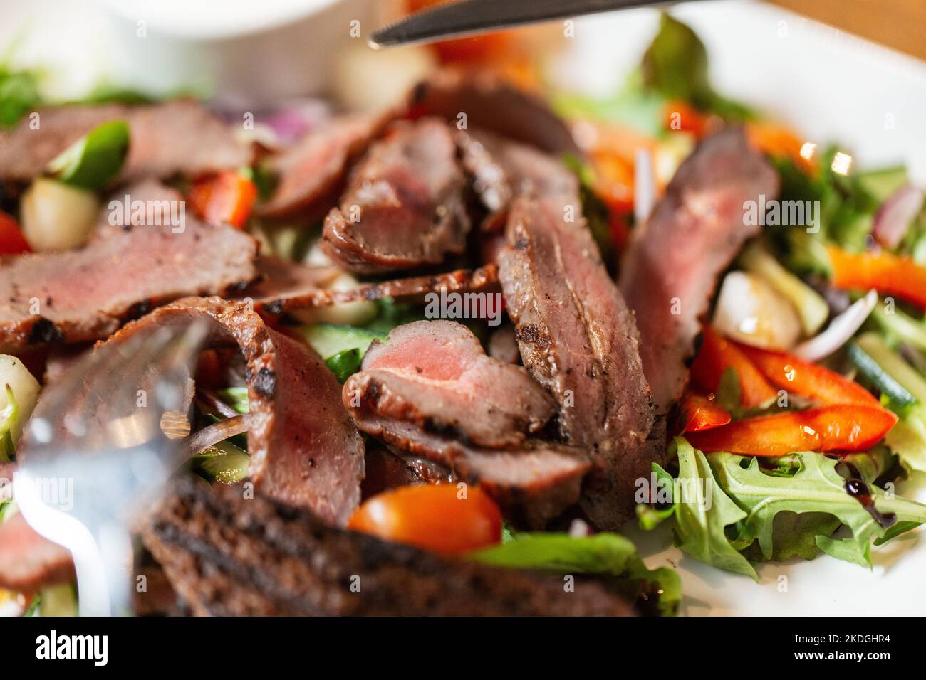 close up of meat with vegetable salad on plate Stock Photo