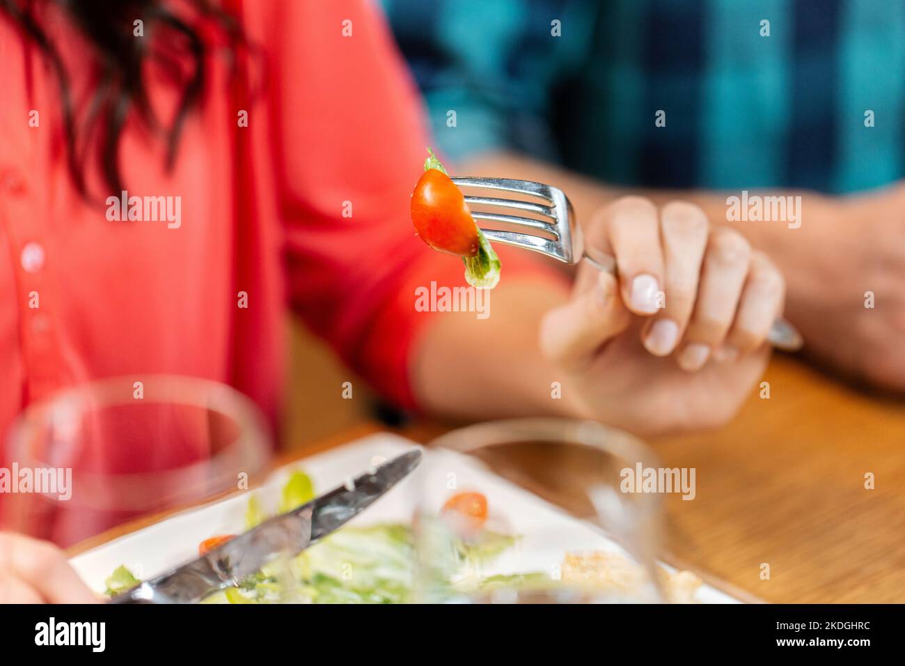 close up of woman eating at restaurant Stock Photo