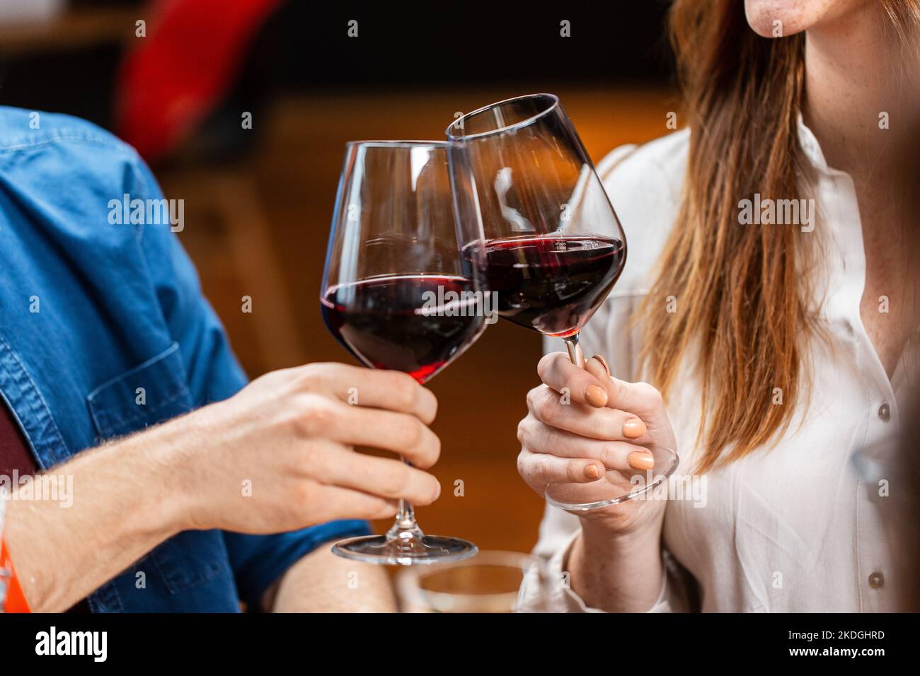 close up of couple drinking red wine at restaurant Stock Photo