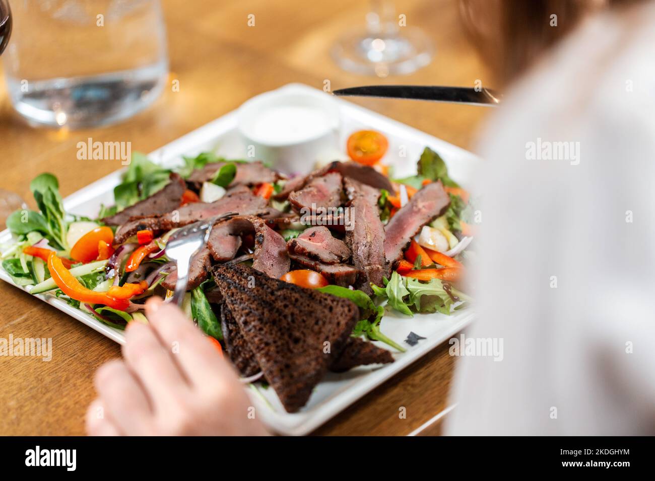 close up of woman eating at restaurant Stock Photo