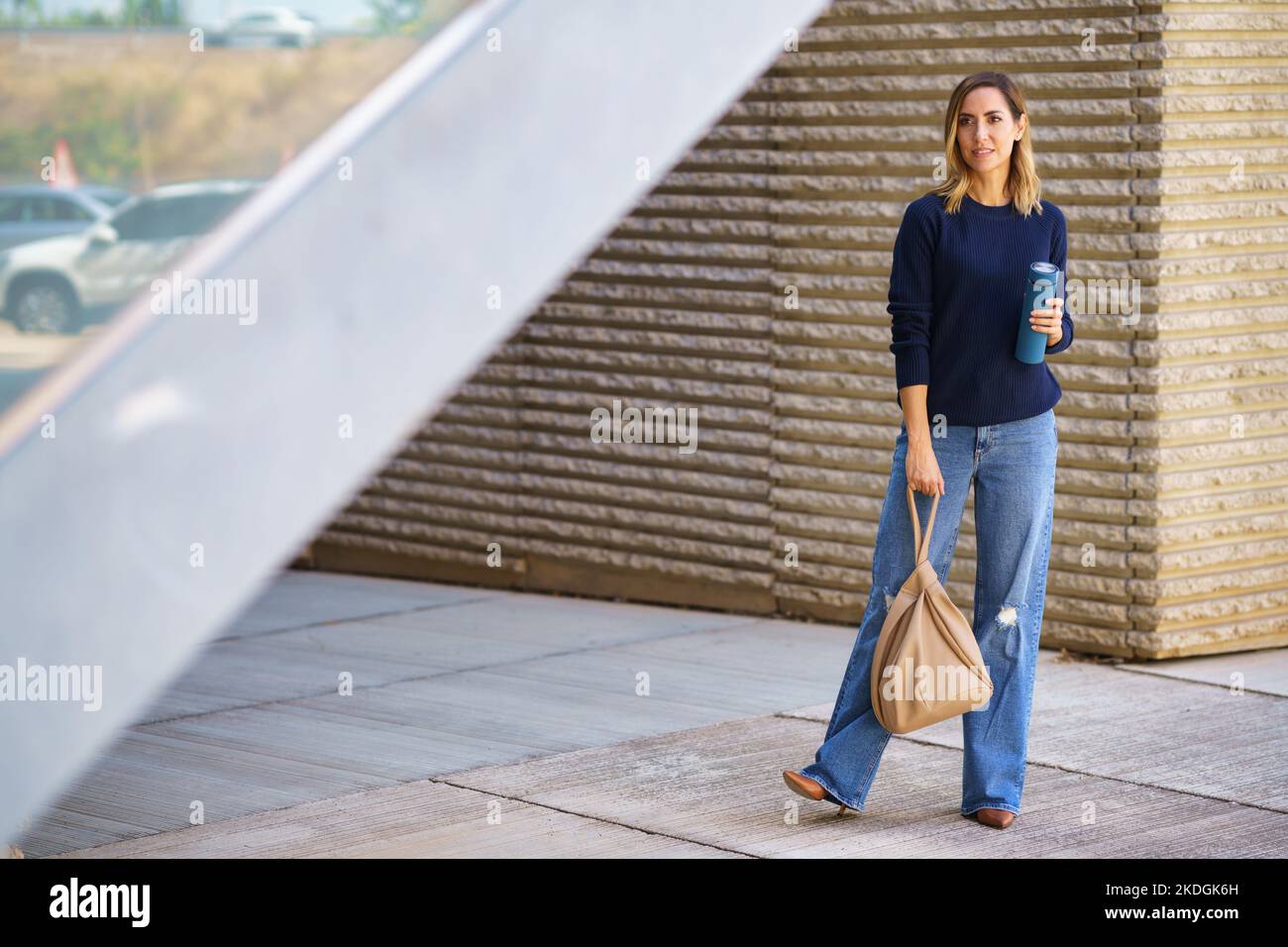 Woman standing on pavement hi-res stock photography and images - Alamy