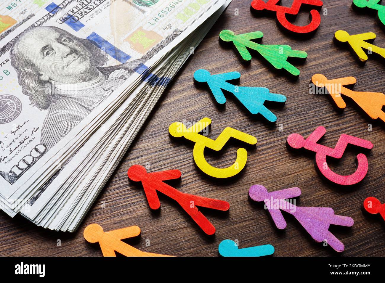 Colorful figures and money. Income inequality and wage gap concept. Stock Photo