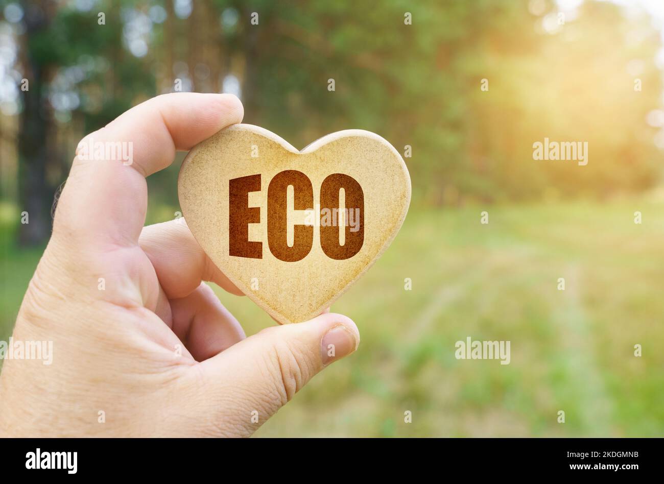 Ecological concept. In the hands of a man is a tablet in the form of a heart on which it is written - Eco Stock Photo