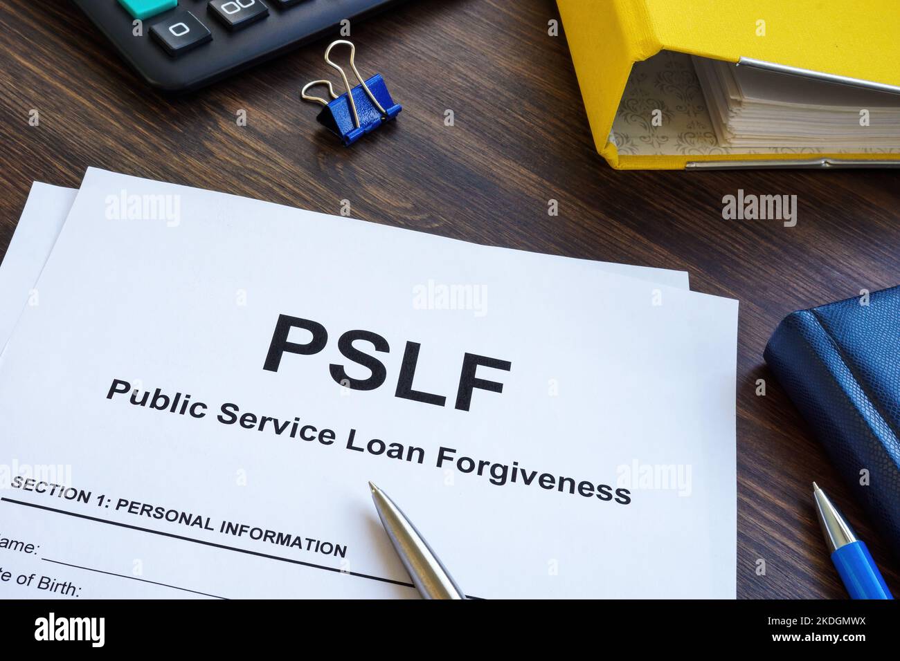Papers foe Public Service Loan Forgiveness PSLF on the wooden surface. Stock Photo