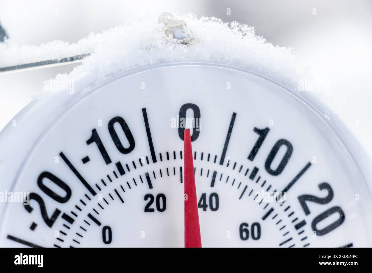 Outside thermometer showing lightly under frozen temperature, zero Celcius degrees or minus 32 Farhenheit. Winter snowing day. Stock Photo