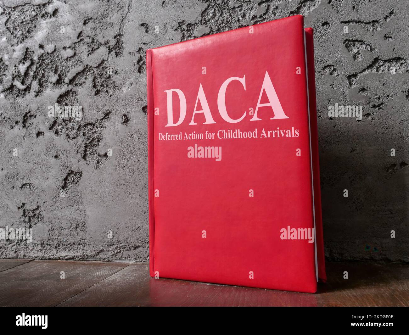 Book Deferred Action for Childhood Arrivals DACA law near the wall. Stock Photo