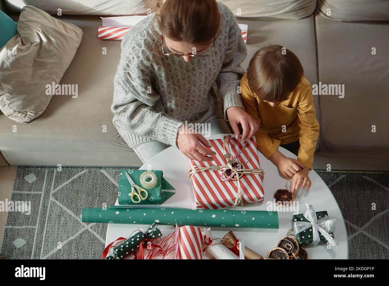 Decorating Christmas gifts, family mother and child wrapping Christmas