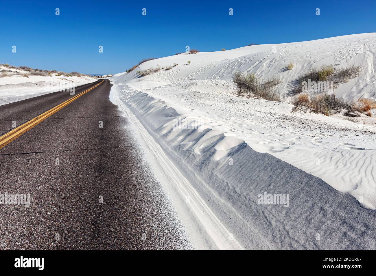 Road heading into White Sands National Park, New Mexico Stock Photo