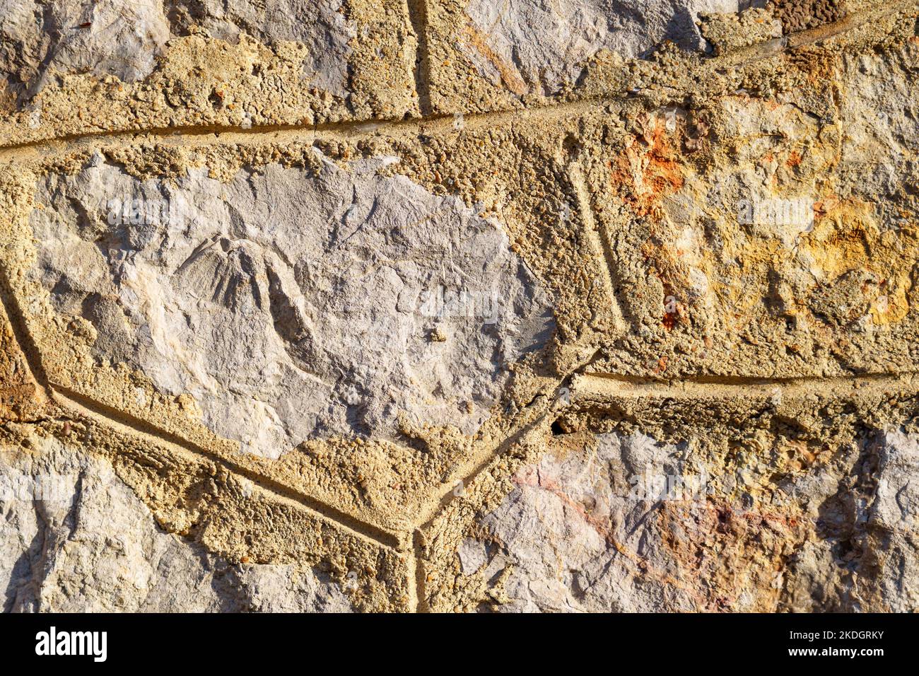 Old stone wall with cement tile pattern. Rough grunge background Stock Photo