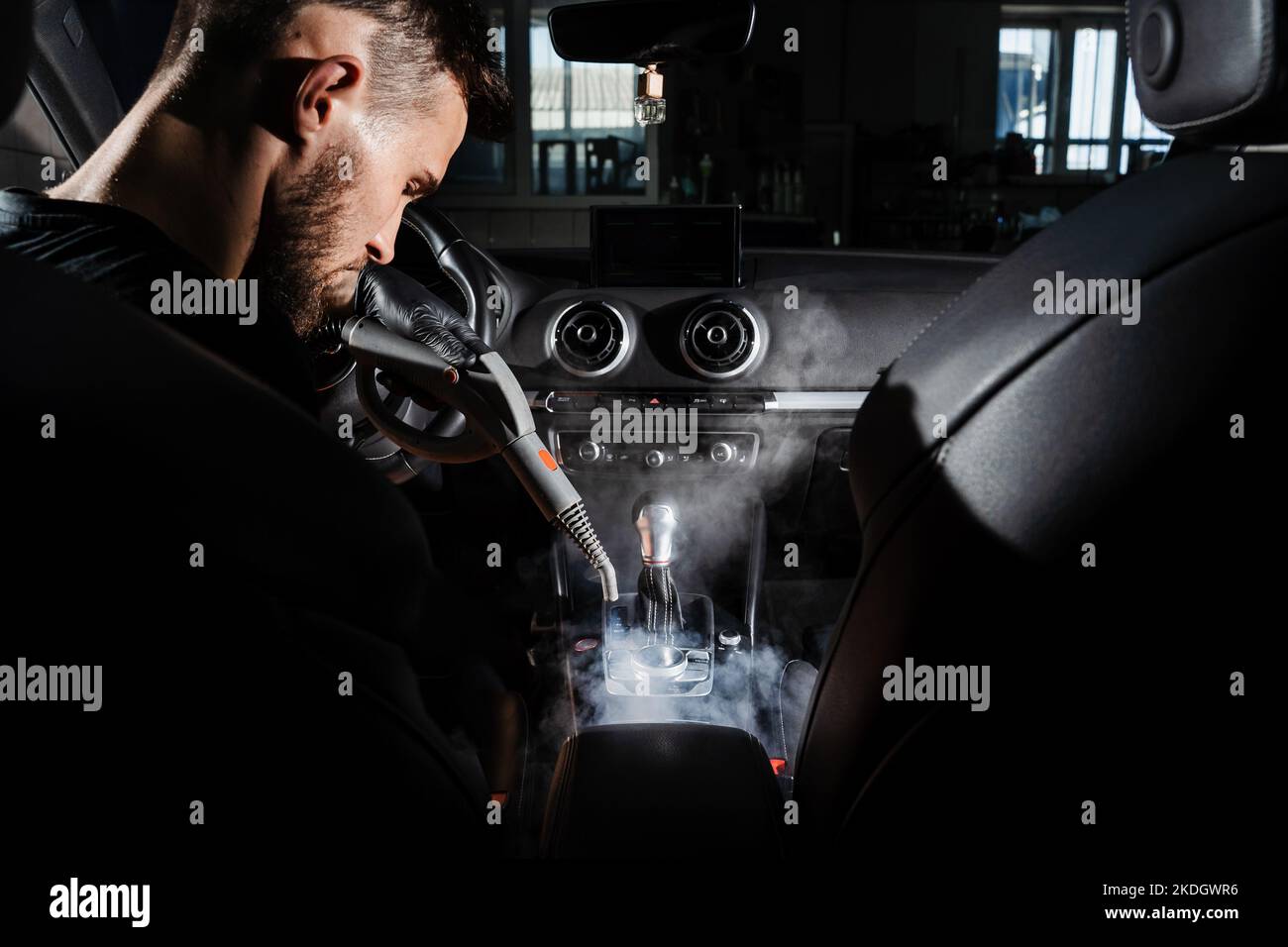 Steam cleaning of gearbox and dashboard in car. Vaping steam. Cleaning