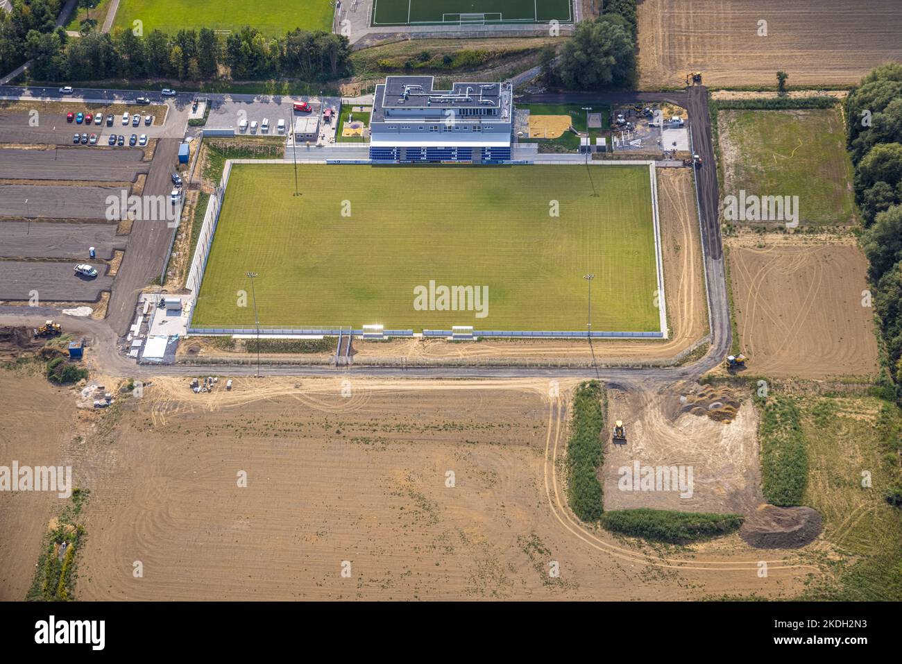 Aerial view, construction site and new construction sports field with stands and club building with sports day care center, An der Lohschule, Rhynern, Stock Photo