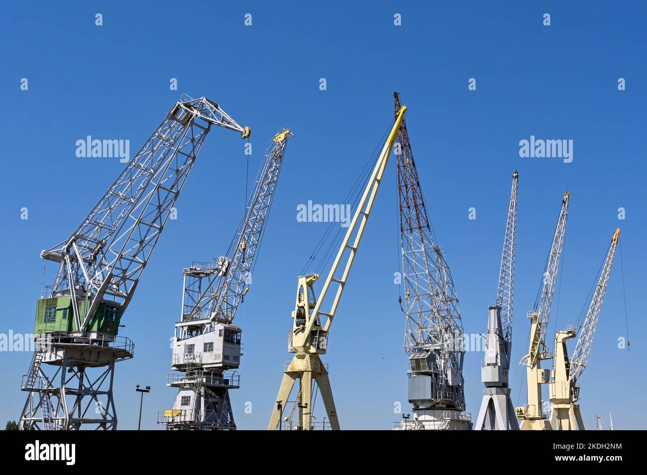 Antwerp, Belgium - August 2022: Row of old cranes in one of the city's docks Stock Photo