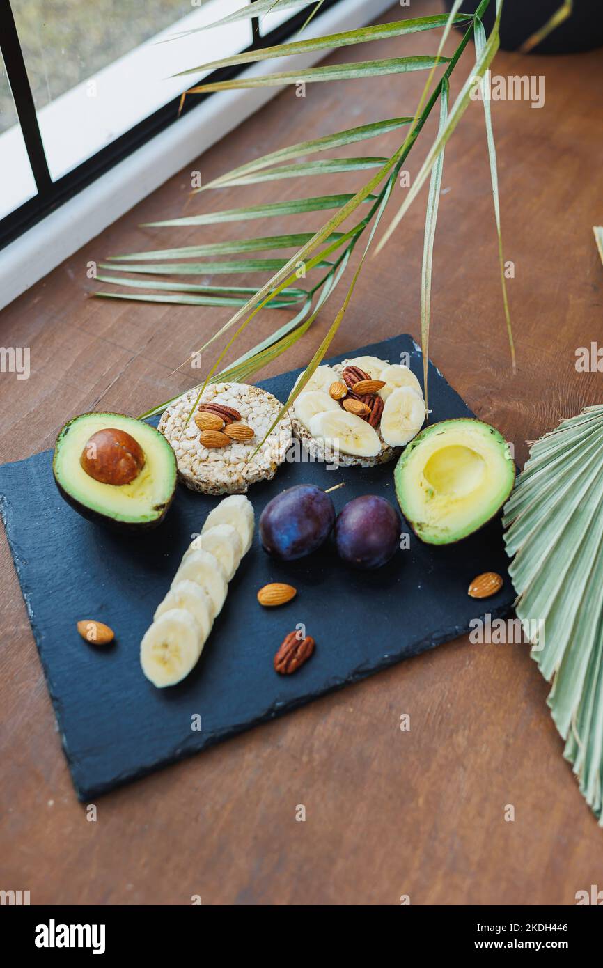 Vegan rice bread for breakfast with avocado and plums. Healthy Eating Stock Photo Alamy