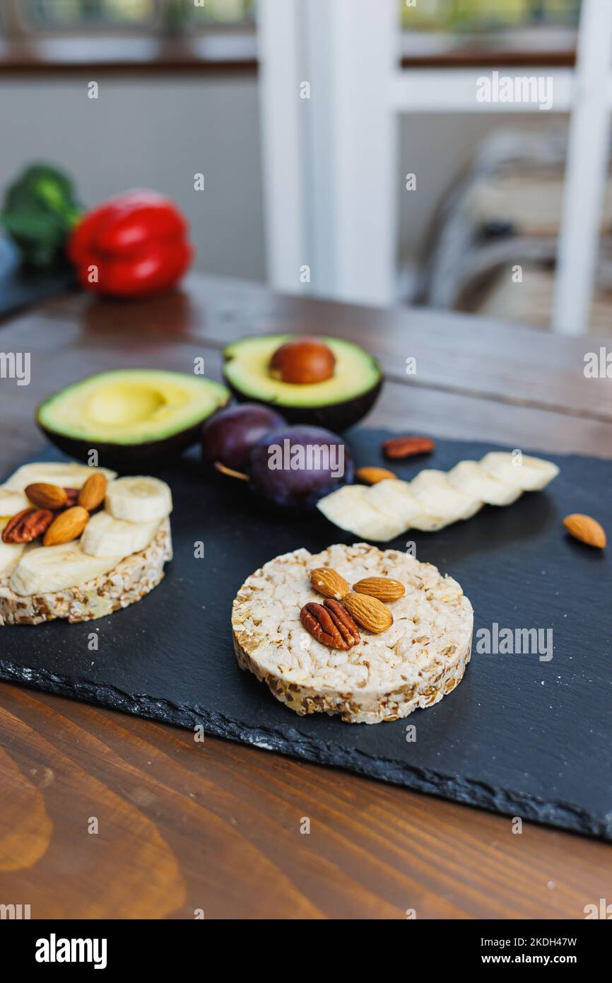 Vegan rice bread for breakfast with avocado and plums. Healthy Eating