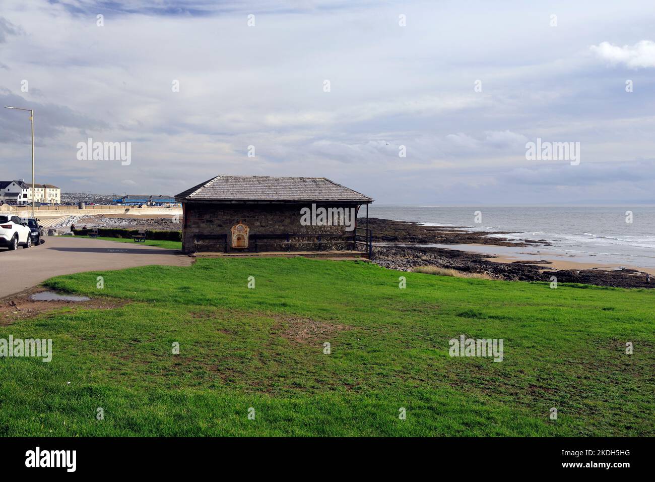Grey stone shelter with slate roof, near Porthcawl beach on grassy