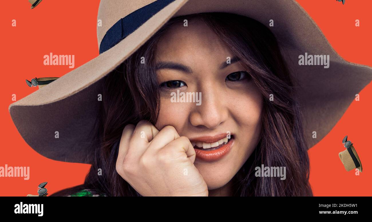 Close-up portrait of smiling young asian woman wearing hat with digital headwear Stock Photo
