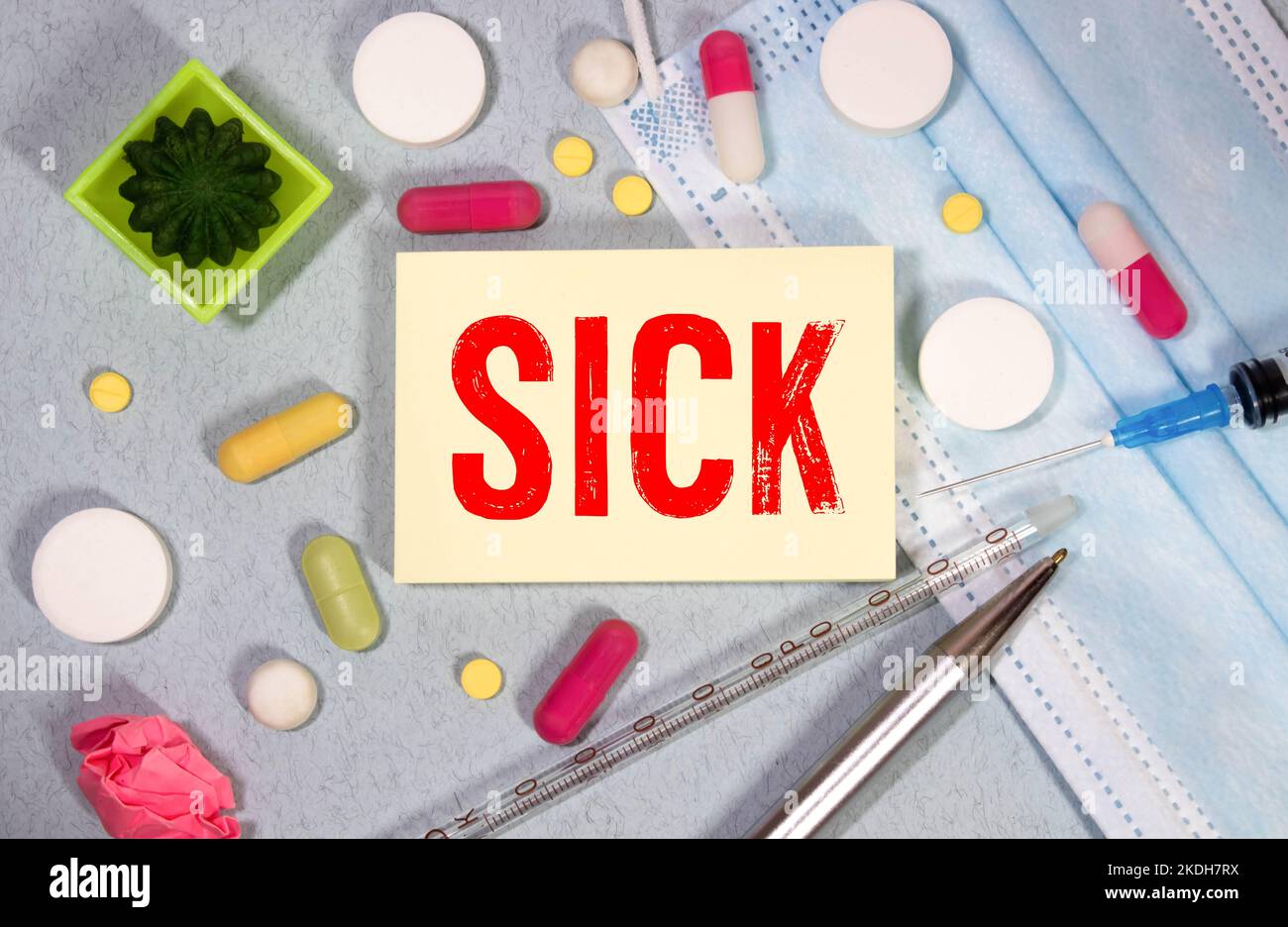 SICK word made on a torn paper, medical concept background. Stock Photo