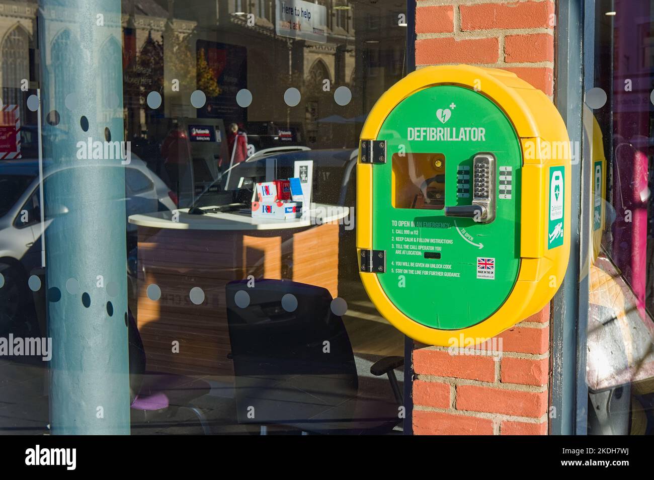 Yellow and green defibrillator machine outside Nationwide in Boston Lincs. Stock Photo