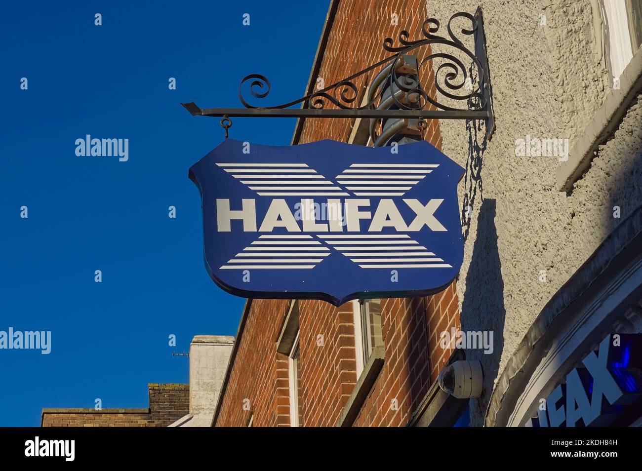 A vintage-style street sign for HALIFAX bank with blue sky in the background. Stock Photo