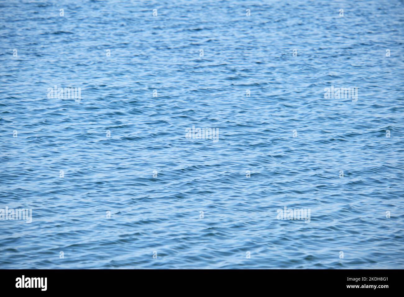 Closeup seascape surface of blue sea water with small ripple waves ...