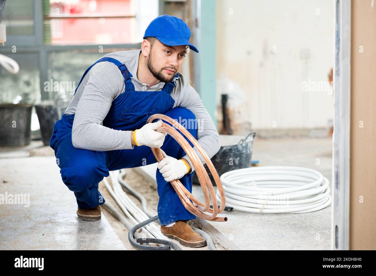 Man electrical installer laying cables through trench Stock Photo Alamy