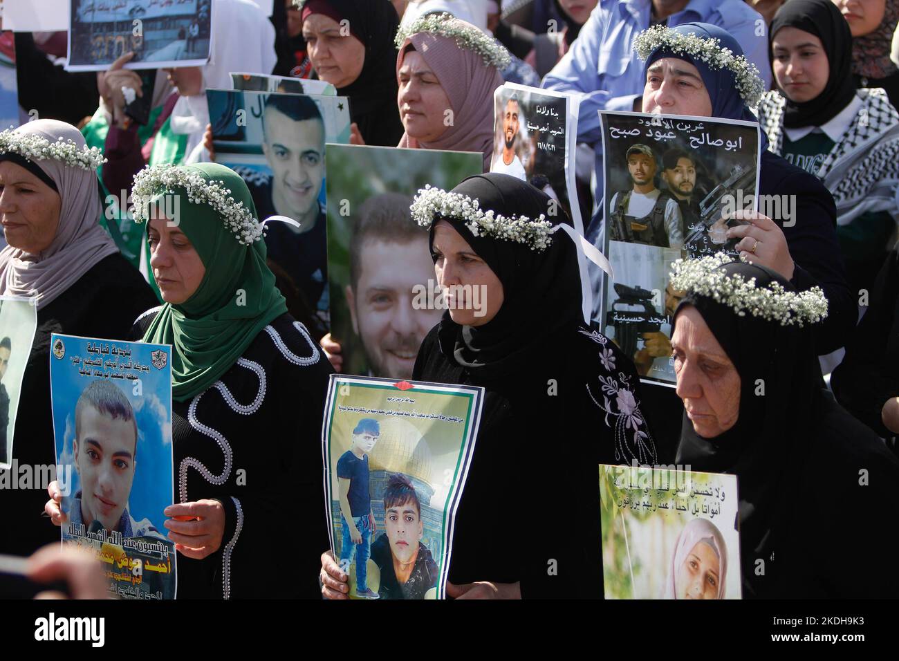 Palestinian women hold pictures of Palestinians who were shot dead by the Israeli army during a protest in Nablus. Palestinians stage a protest against the killing of Palestinian youths during a raid on West Bank. Israeli army has killed nearly 180 Palestinians in the West Bank and Gaza since the beginning of this year. Stock Photo