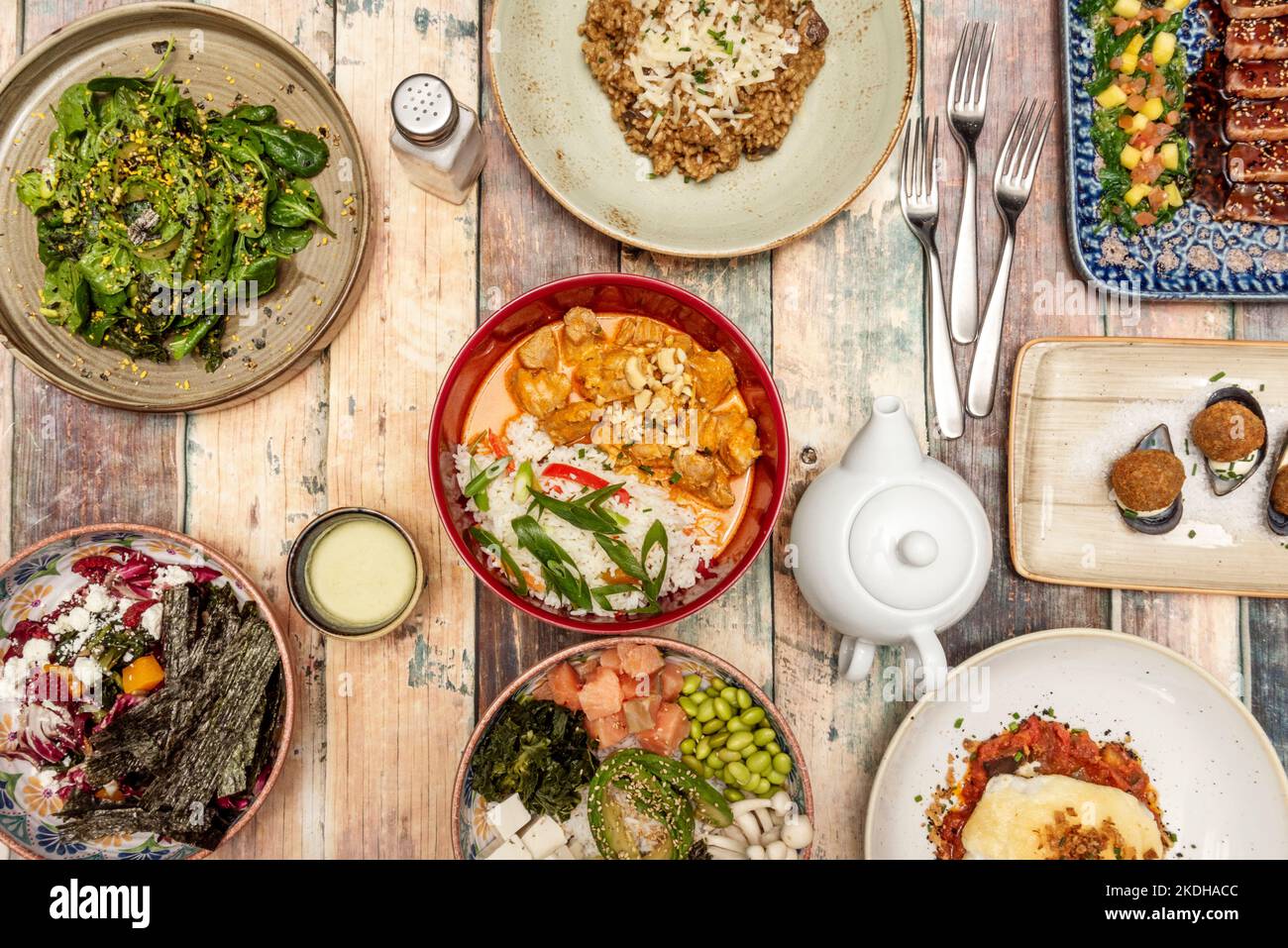 Set of fusion food dishes with a chicken yellow curry with rice and