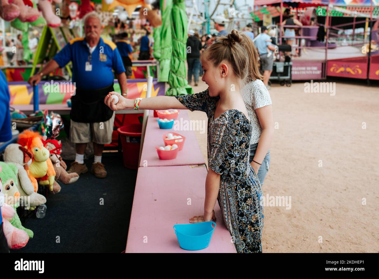 Young girl playing a game at a carnival Stock Photo
