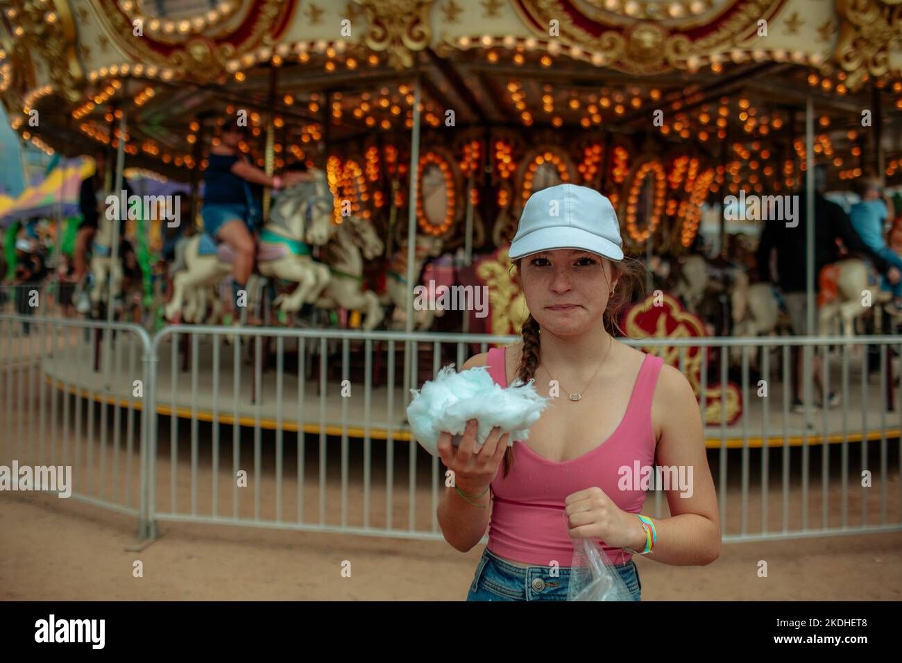 Teenager holding large ball of cotton candy at a carnival Stock Photo Alamy