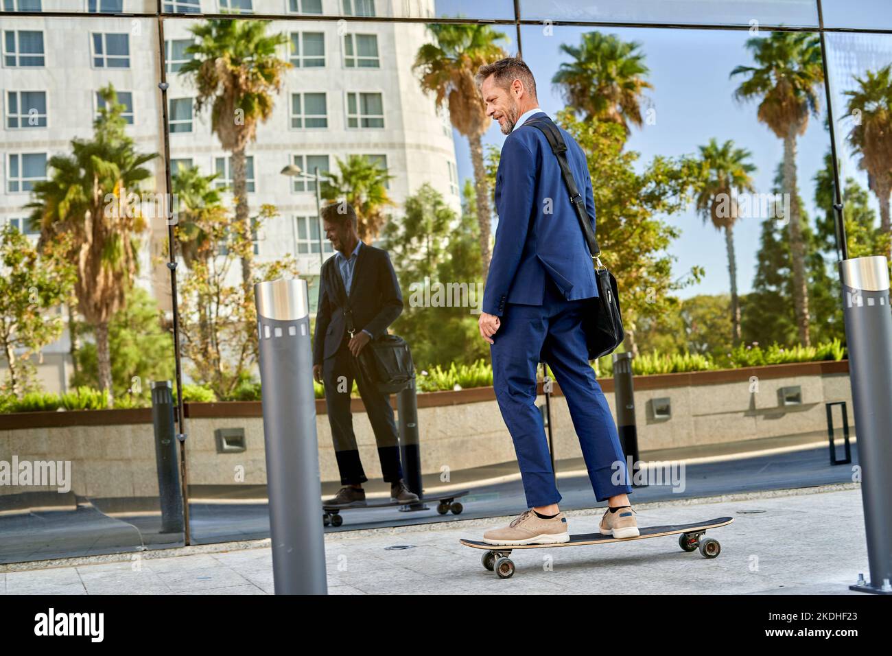 businessman On The Street With A Skateboard. Stock Photo