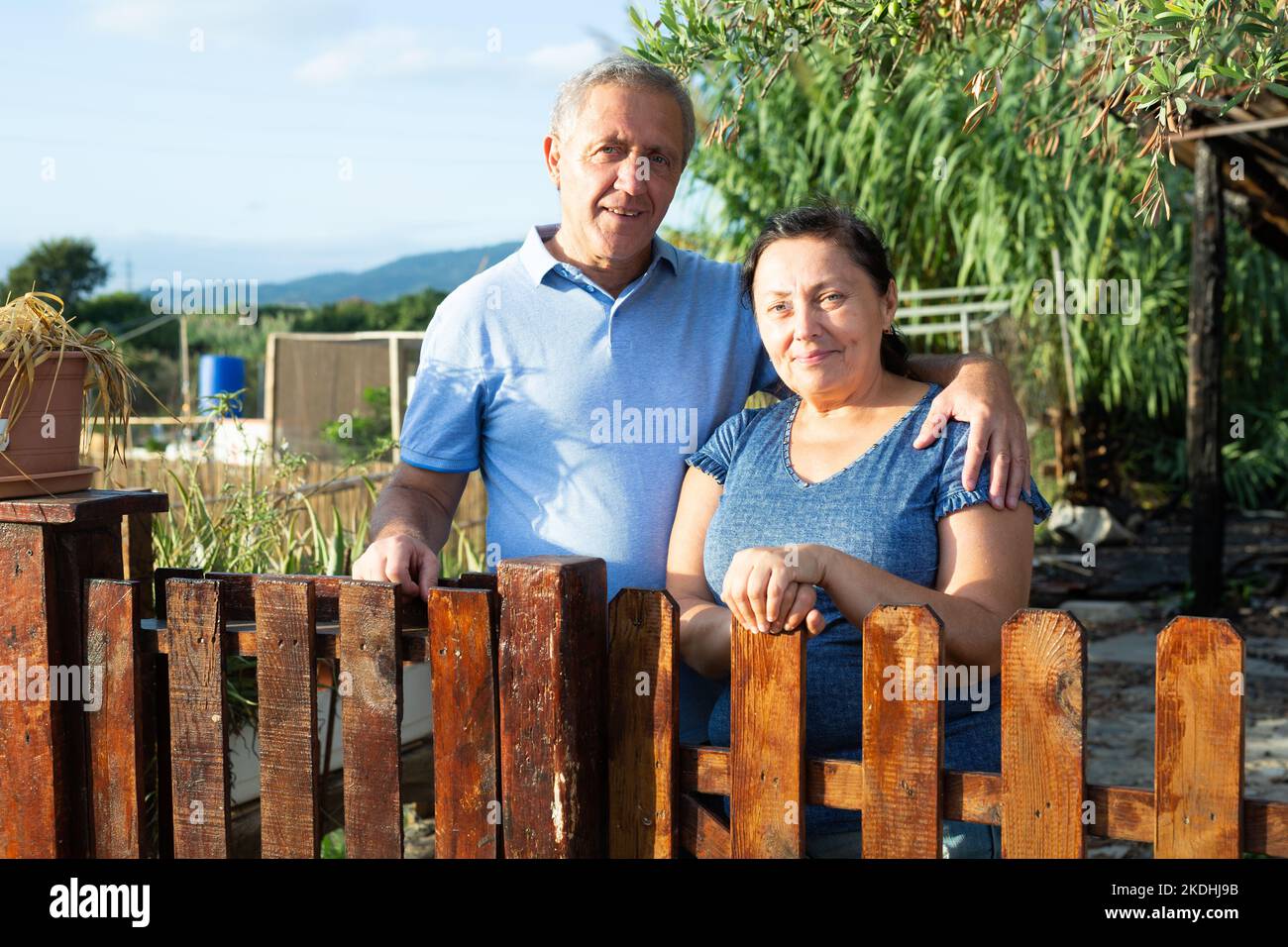 Portrait of positive mature couple in garden outdoors Stock Photo - Alamy