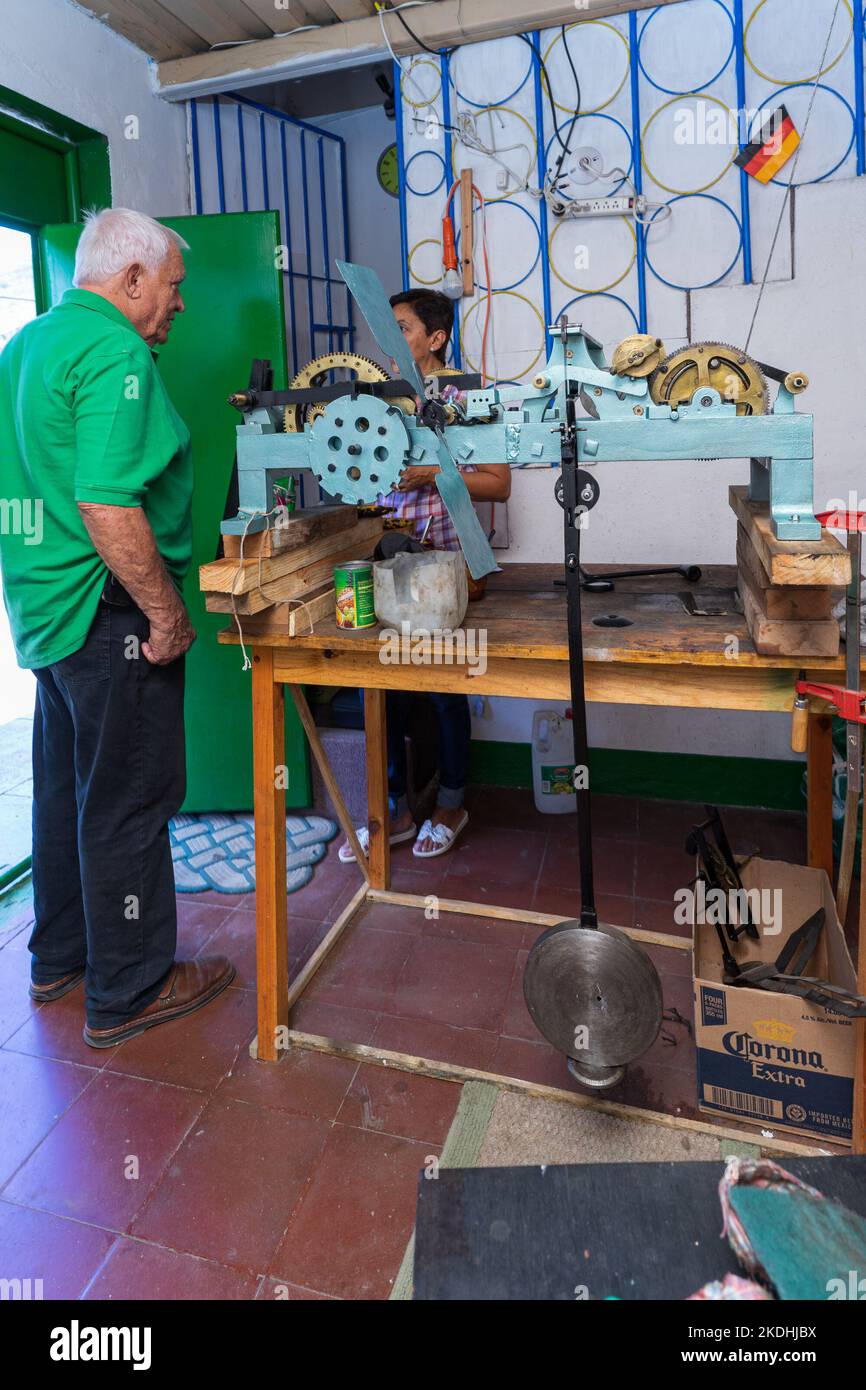 German-Nicaragua clock workshop owner and one of the church cloths being repaired in Jinotega, Nicaragua.  Photo taken with 18mm Zeiss Batis lens. Stock Photo