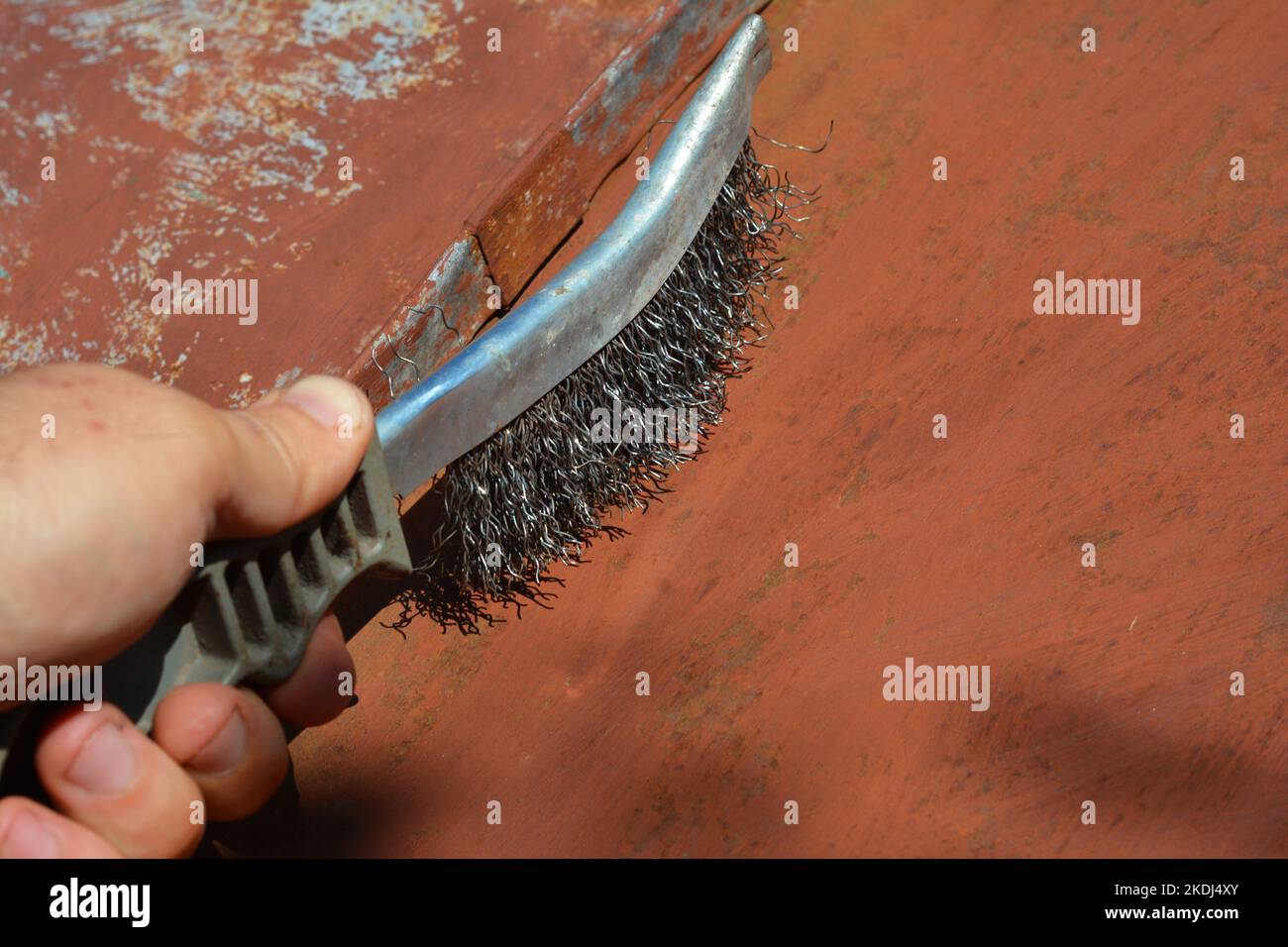 Builder remove old paint and cleaning surface from dust on metal roof