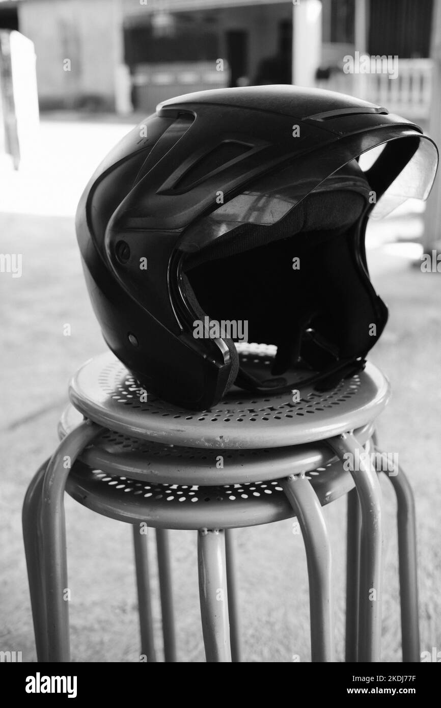 Black and white photo, Monochrome photo of a helmet on a chair in the Cikancung area - Indonesia Stock Photo