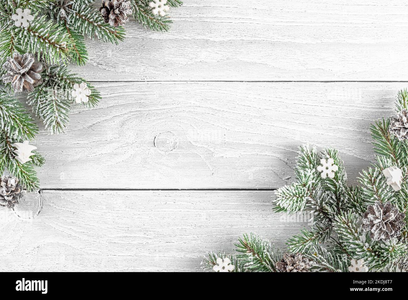 Christmas composition made of fir tree, festive silver decorations on white wooden background. Flat lay. Minimal layout. Top view with copy space. Win Stock Photo