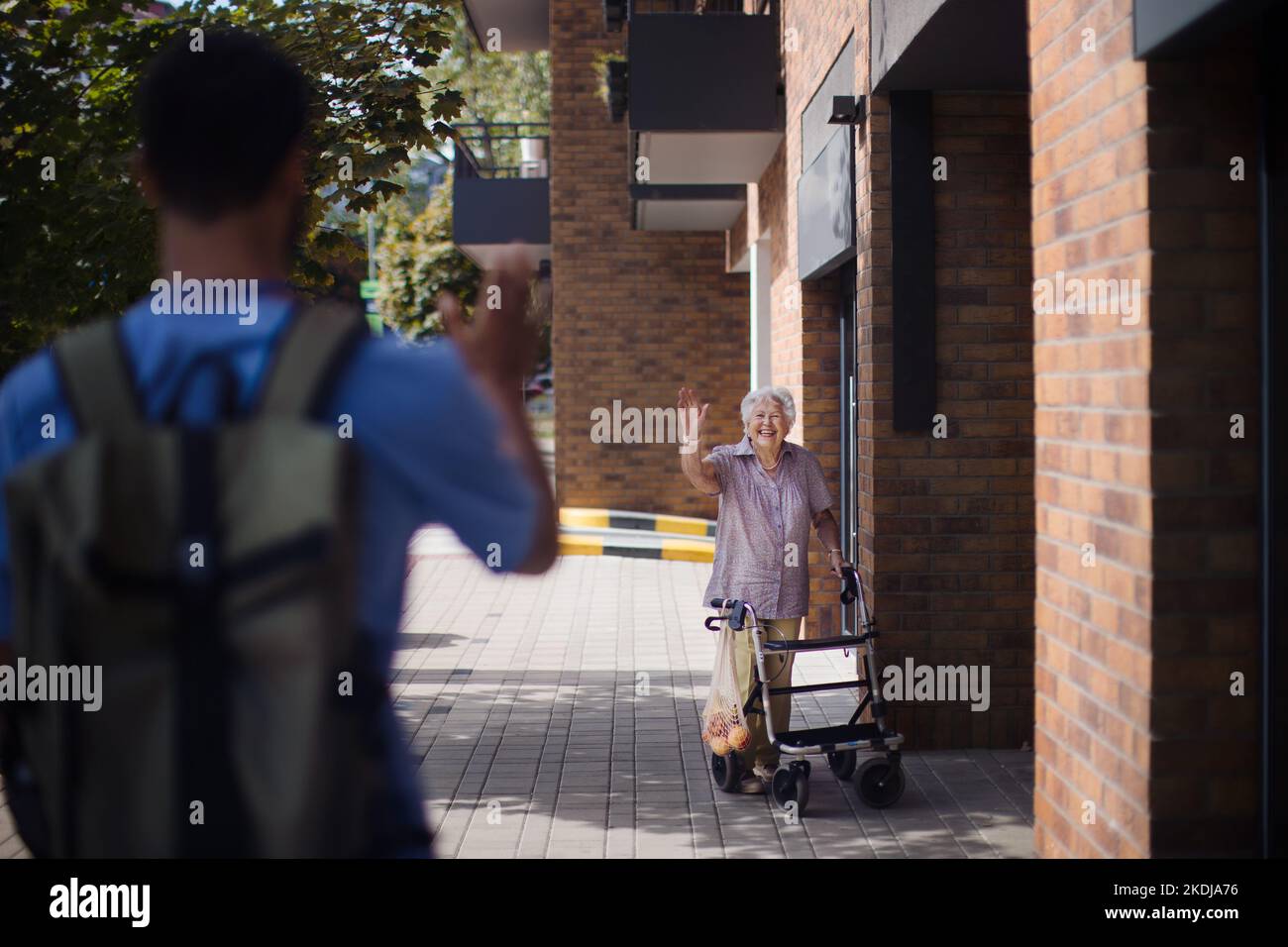 Caregiver saying goodbye his senior woman client at nursing home Stock Photo Alamy