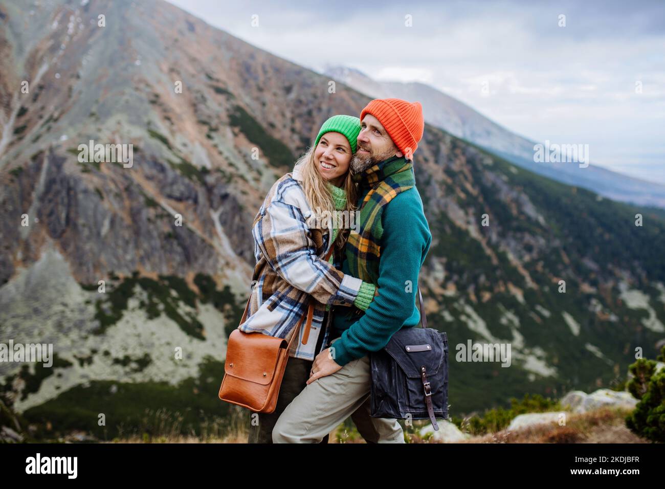 Young happy couple at mountain hike, hugging each other Stock Photo - Alamy