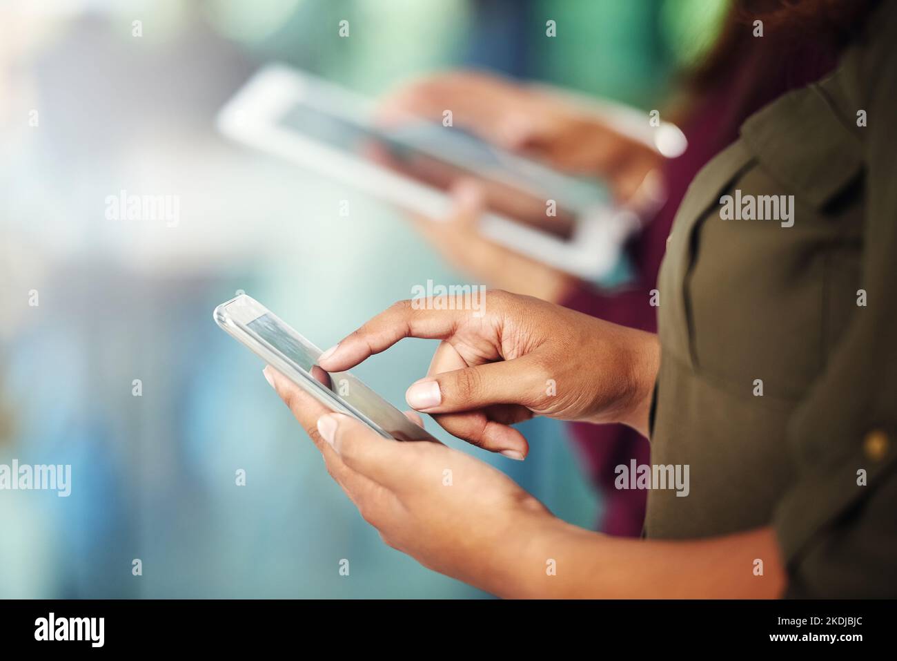 Someone Using Internet Using Devices Staying in the loop. two unrecognisable people using their digital ...