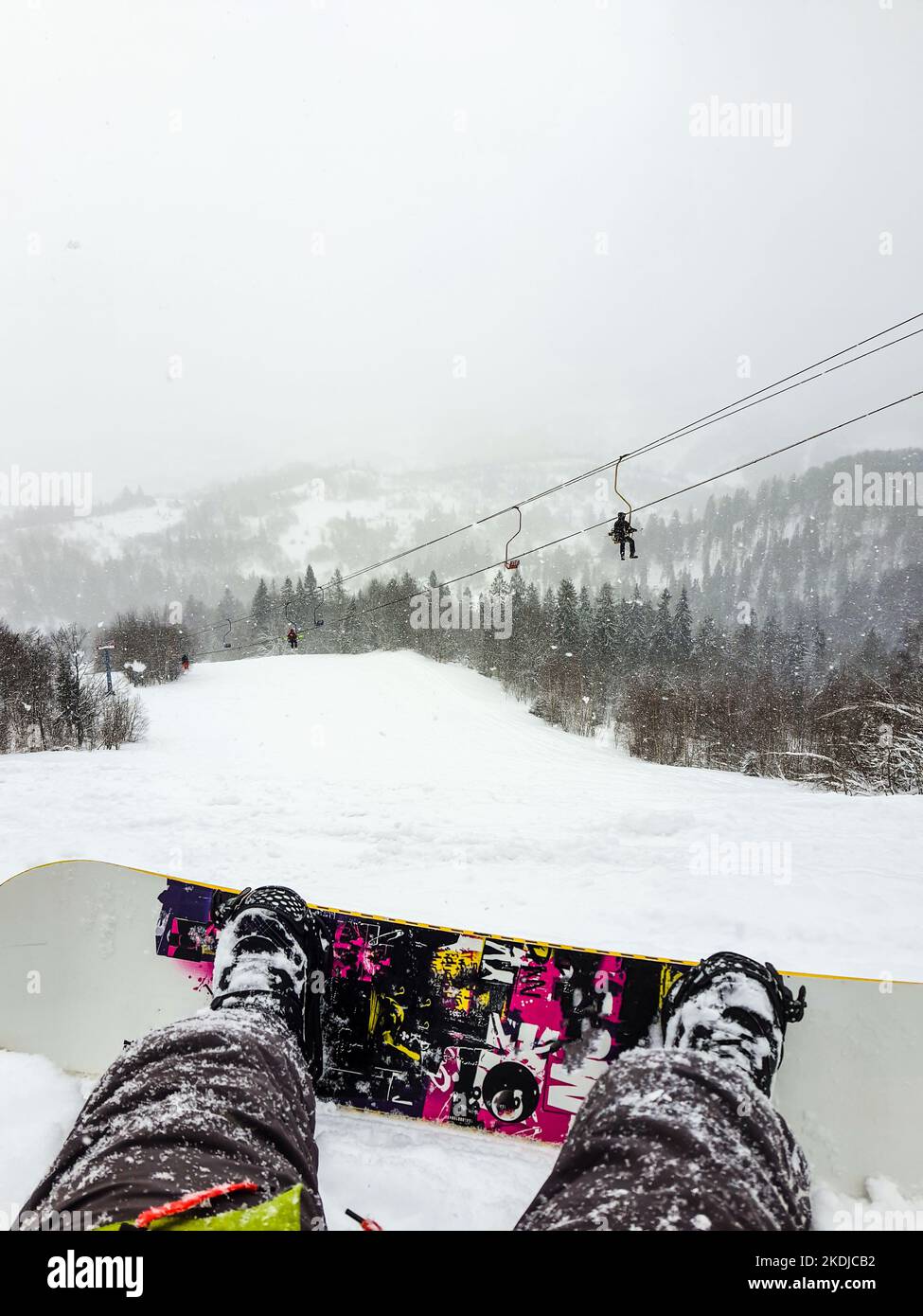 snowboarder sitting on the ski slope Stock Photo