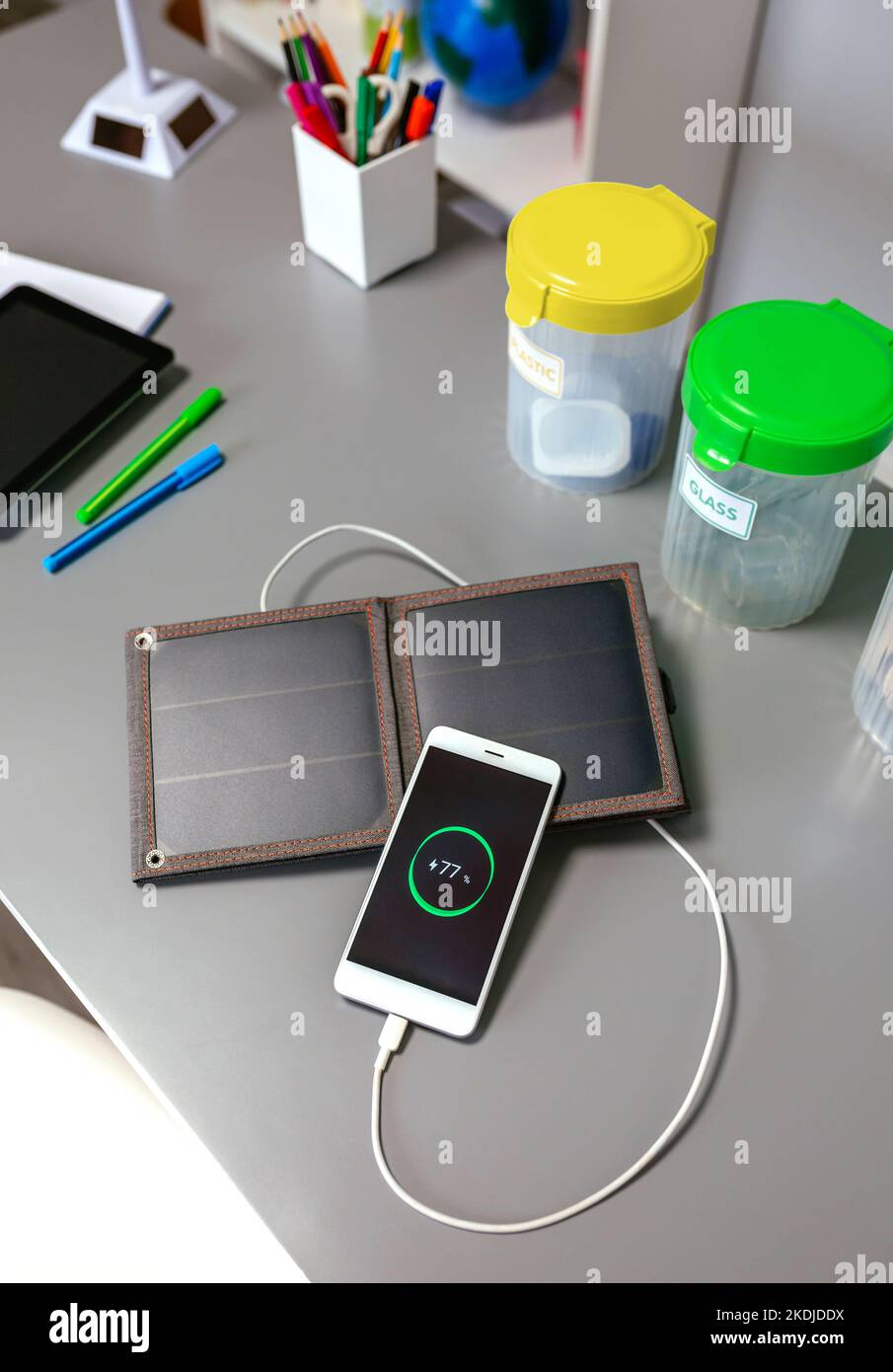 Mobile phone charging with portable solar panel and selective trash