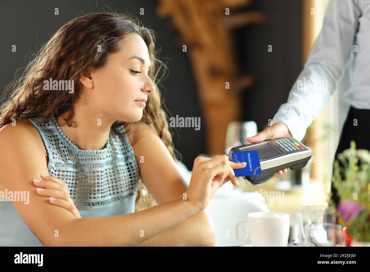 Customer is paying with a credit card and dataphone in a restaurant Stock Photo