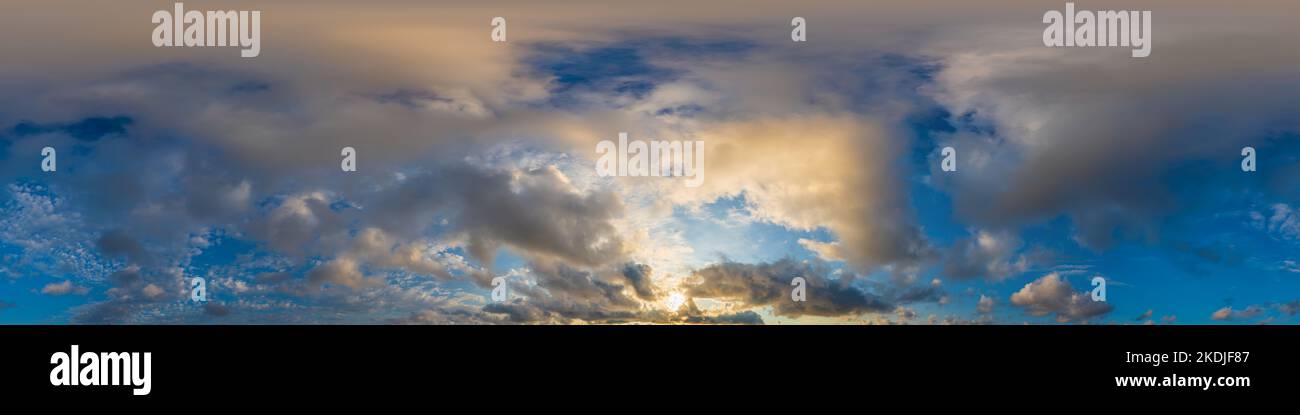 Dark blue sunset sky panorama with golden Cumulus clouds. Seamless hdr 360 panorama in spherical equirectangular format. Full zenith for 3D Stock Photo