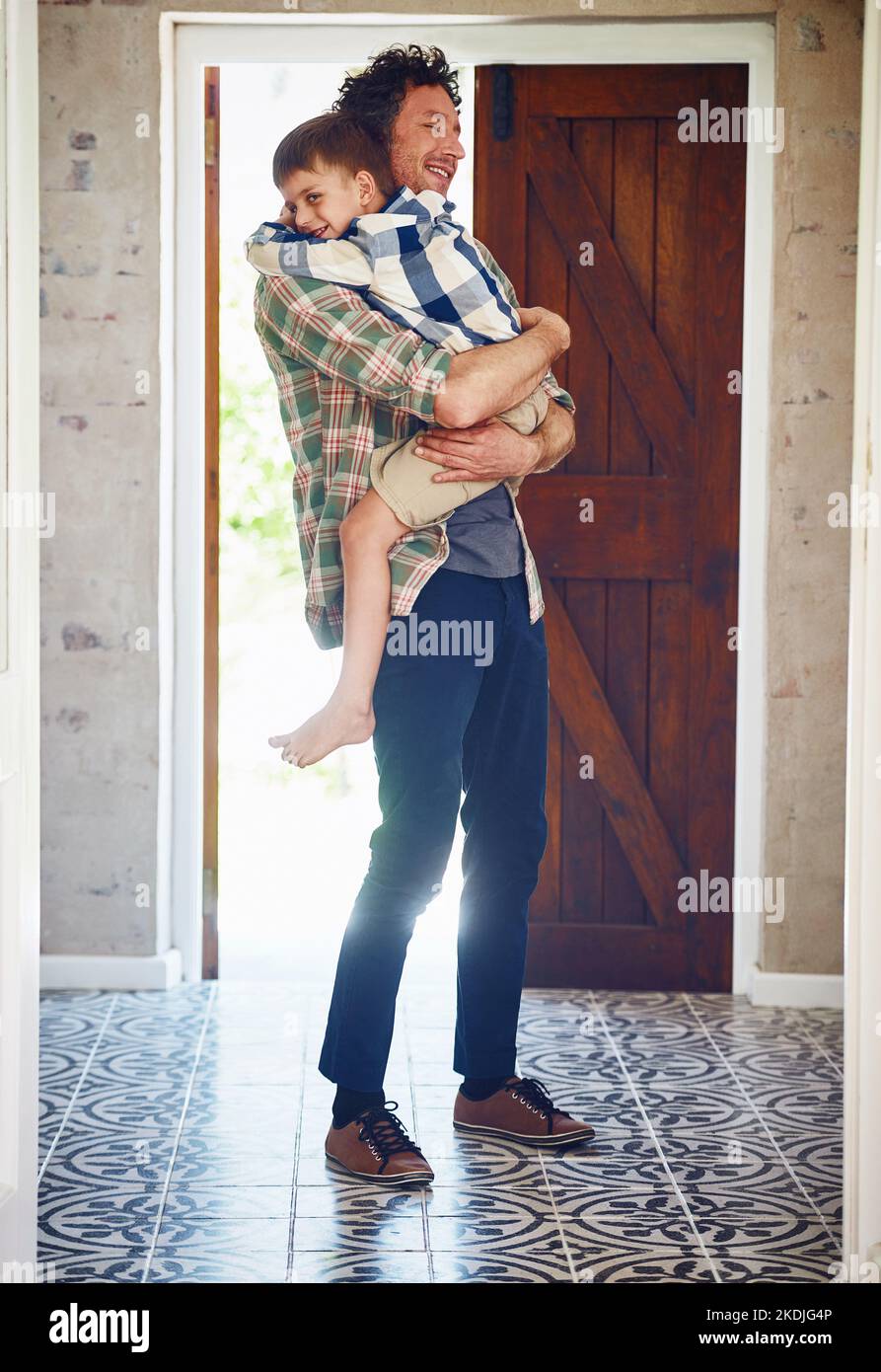Hugging A Lod I missed you a lot, Dad. a father hugging his little son as he enters ...