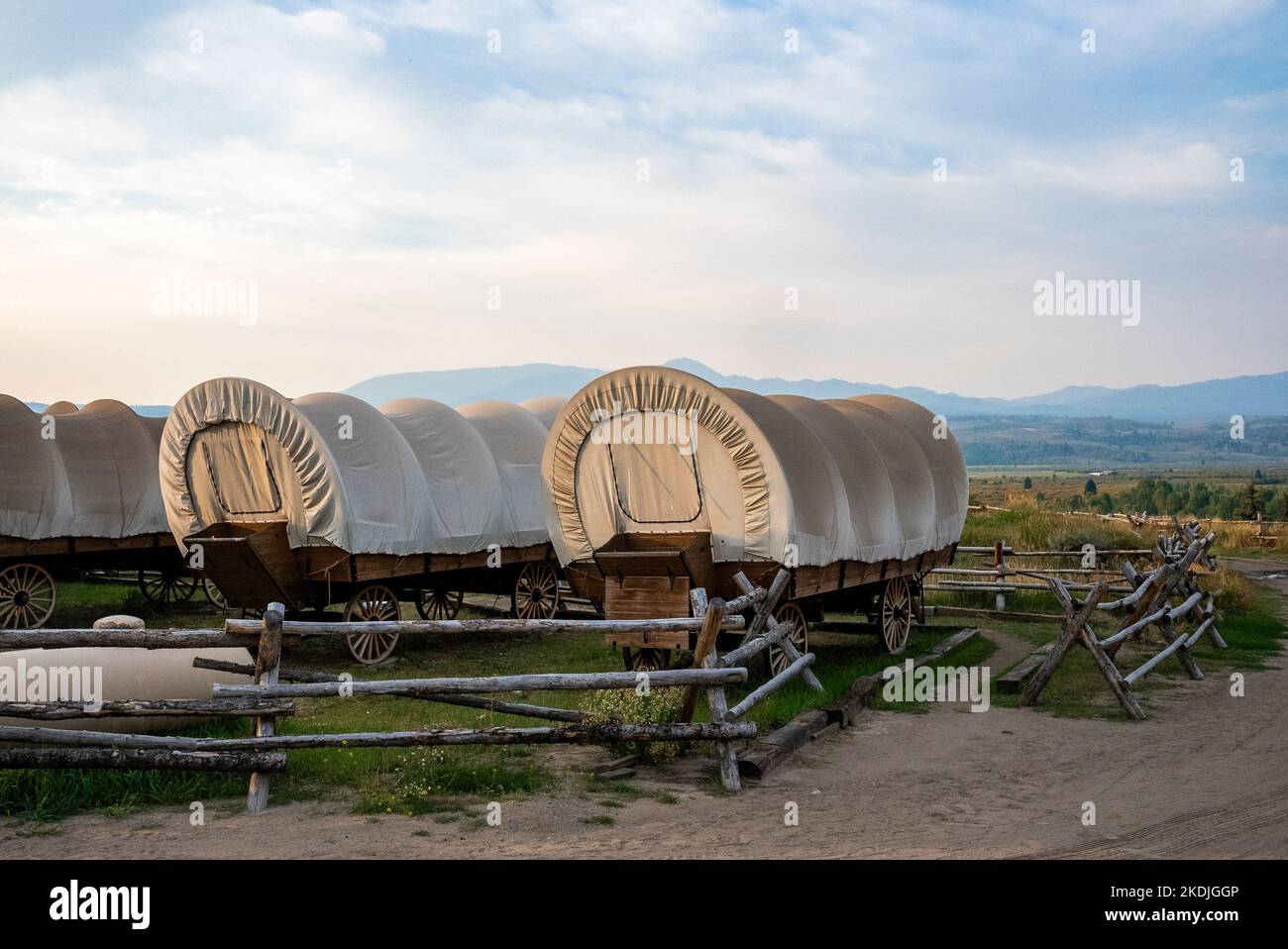 Covered wagons in yard at ranch in Yellowstone park with sky in background Stock Photo Alamy