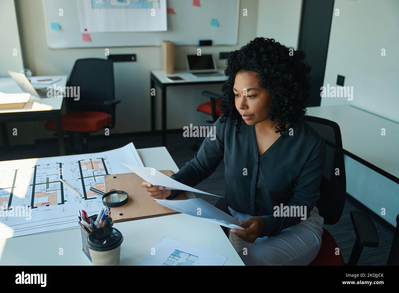 Concentrated multiracial female studies working documents in the office ...