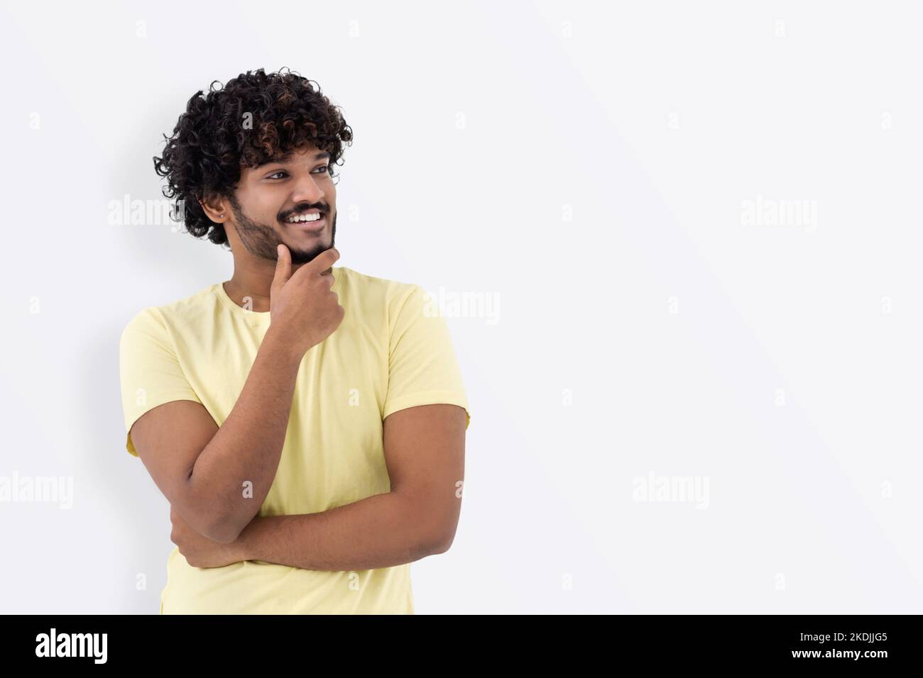Happy man looking away, smiles and thinks about something Stock Photo